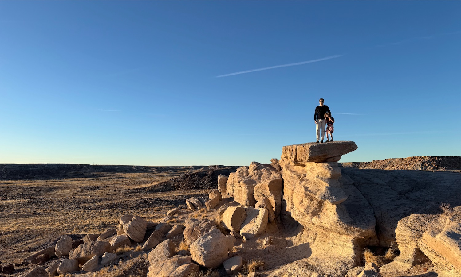 a man and child standing on a rock