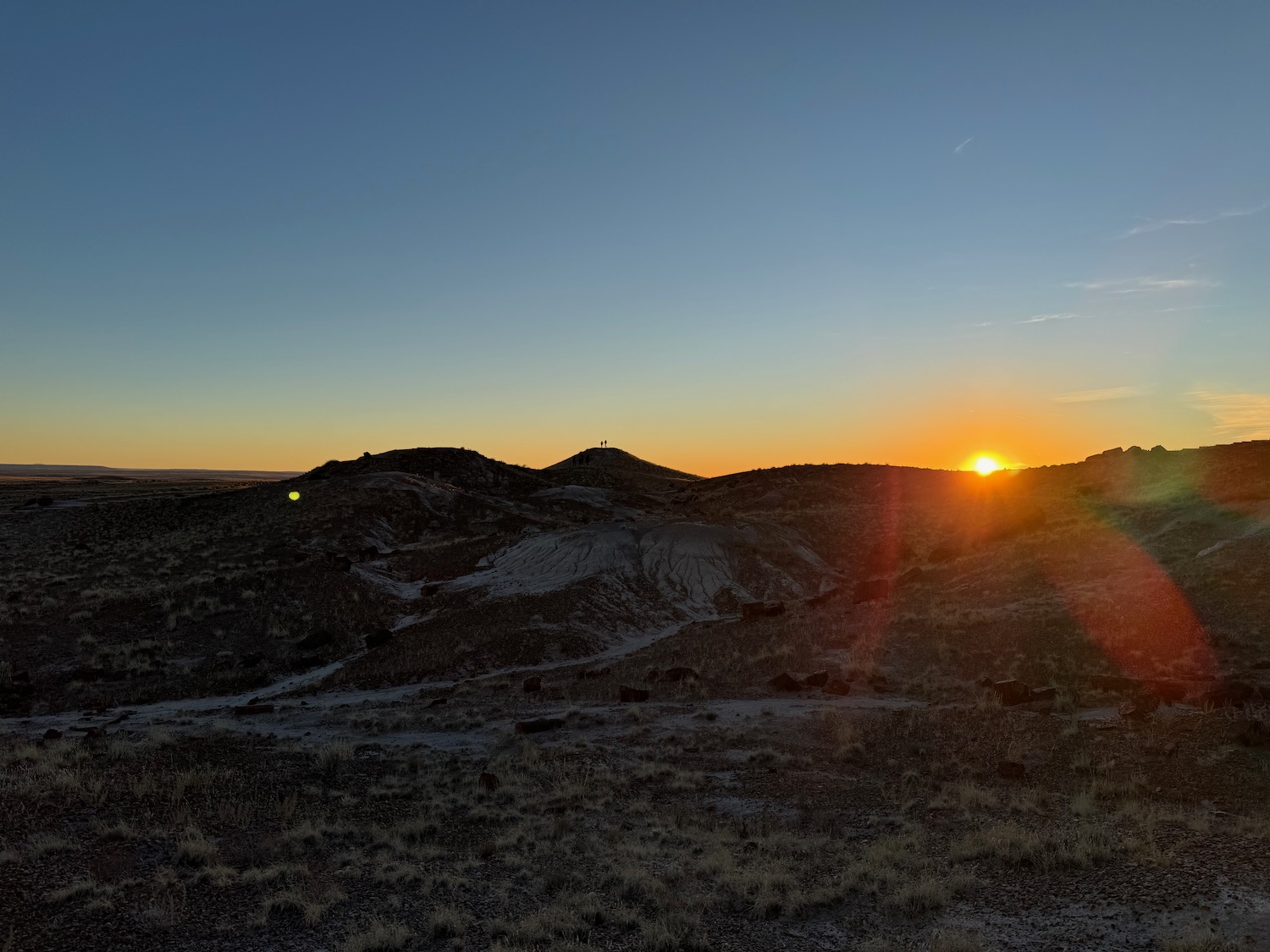 a sunset over a desert