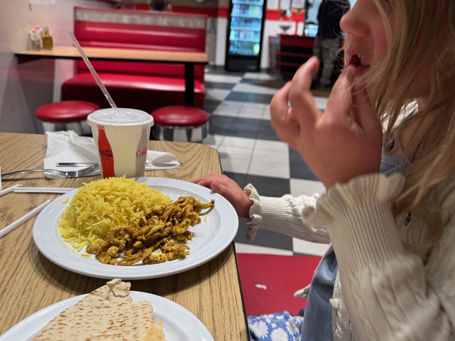 a child eating food at a restaurant