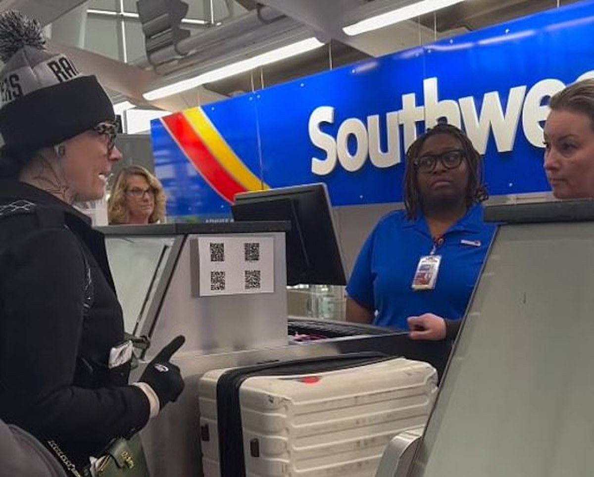 a woman standing next to a woman at a check-in counter