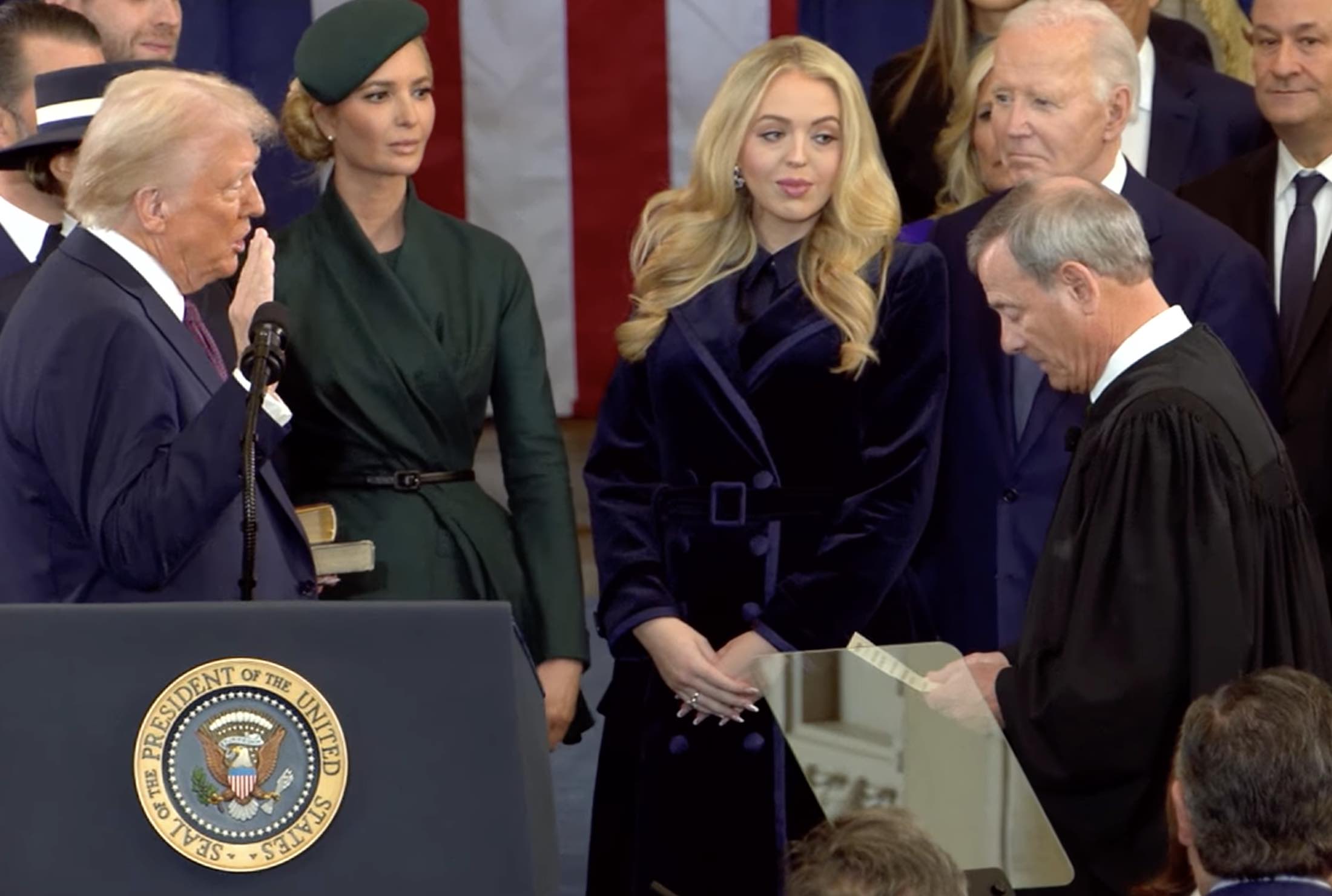 a man standing behind a podium with a woman standing behind him