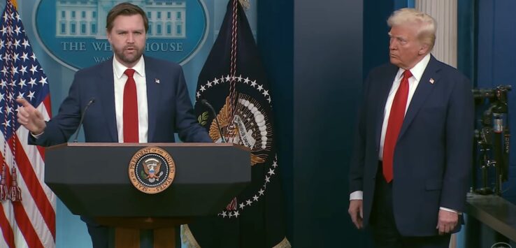 a man standing at a podium with a microphone