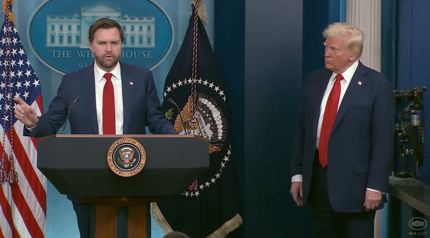 a man standing at a podium with a microphone