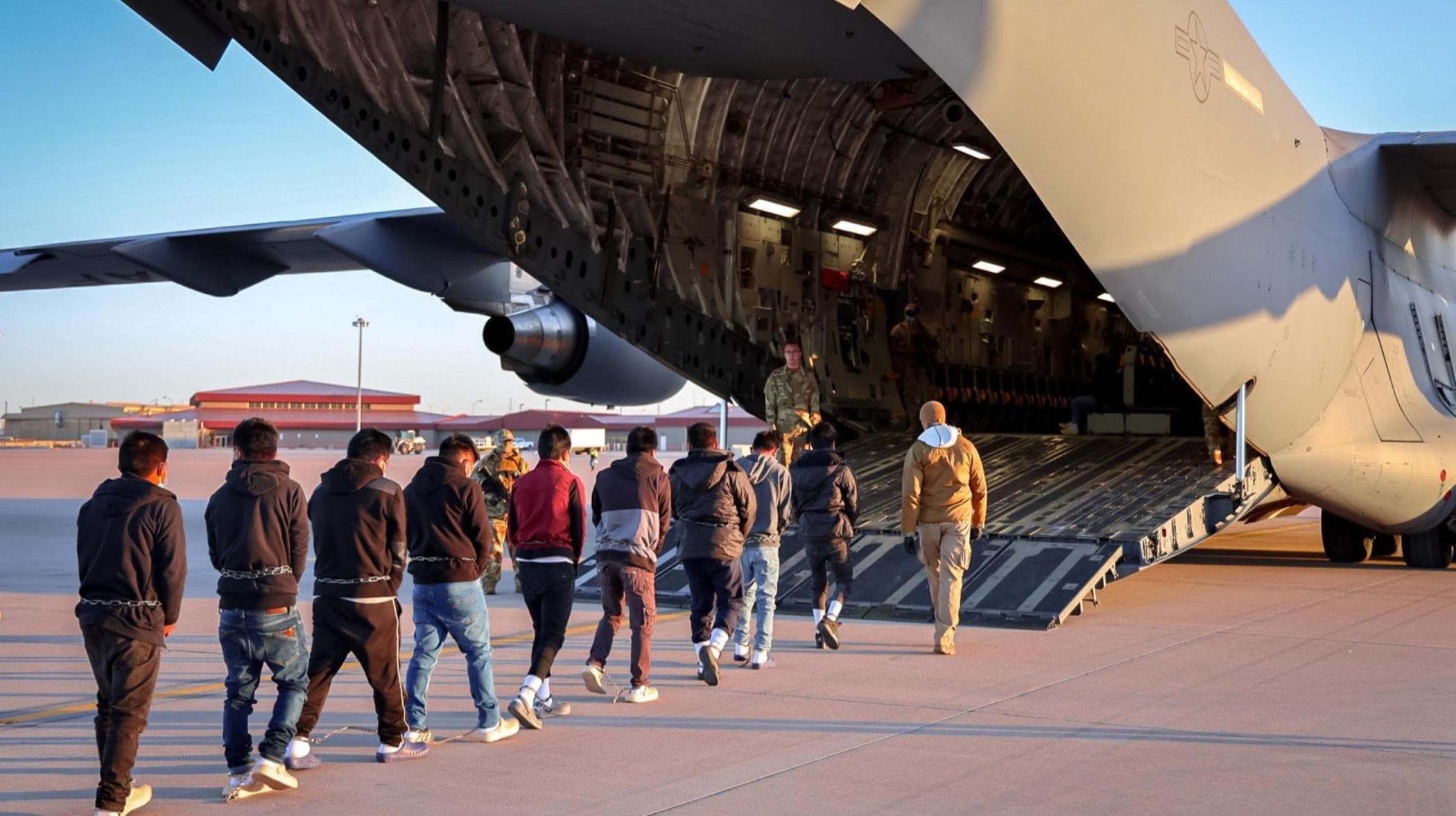 a group of people walking towards an airplane