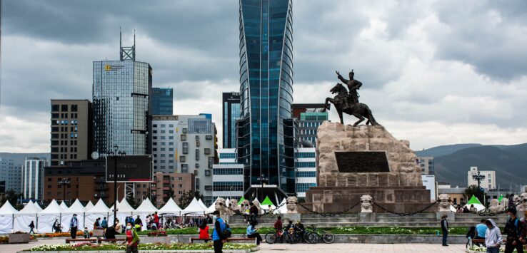 a statue of a man riding a horse in a city