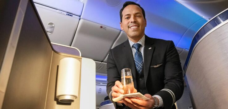 a man in a suit holding a glass of liquid