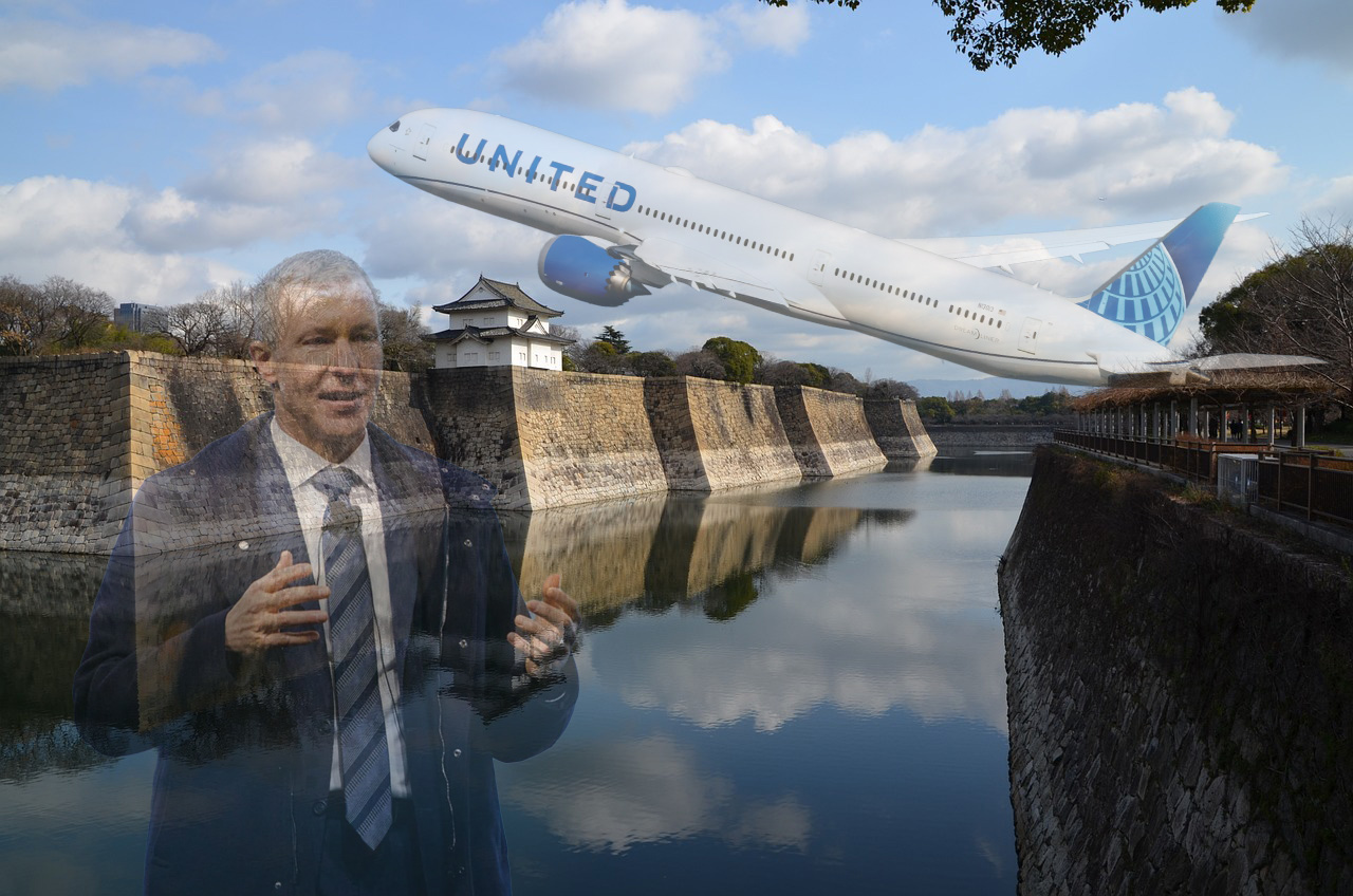 a man in a suit and tie standing in front of a body of water