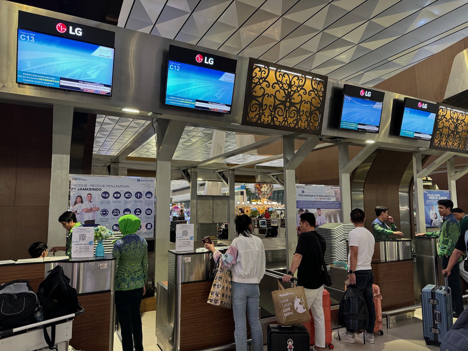 people standing in a line at a check in counter