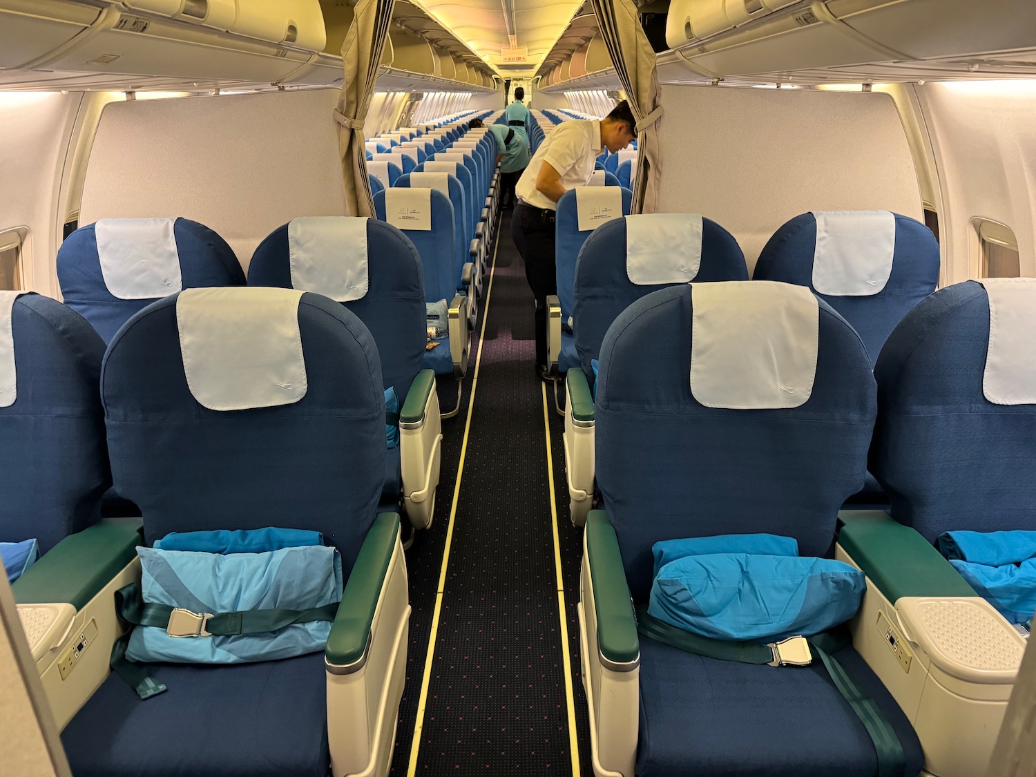 a man standing in a row of blue chairs