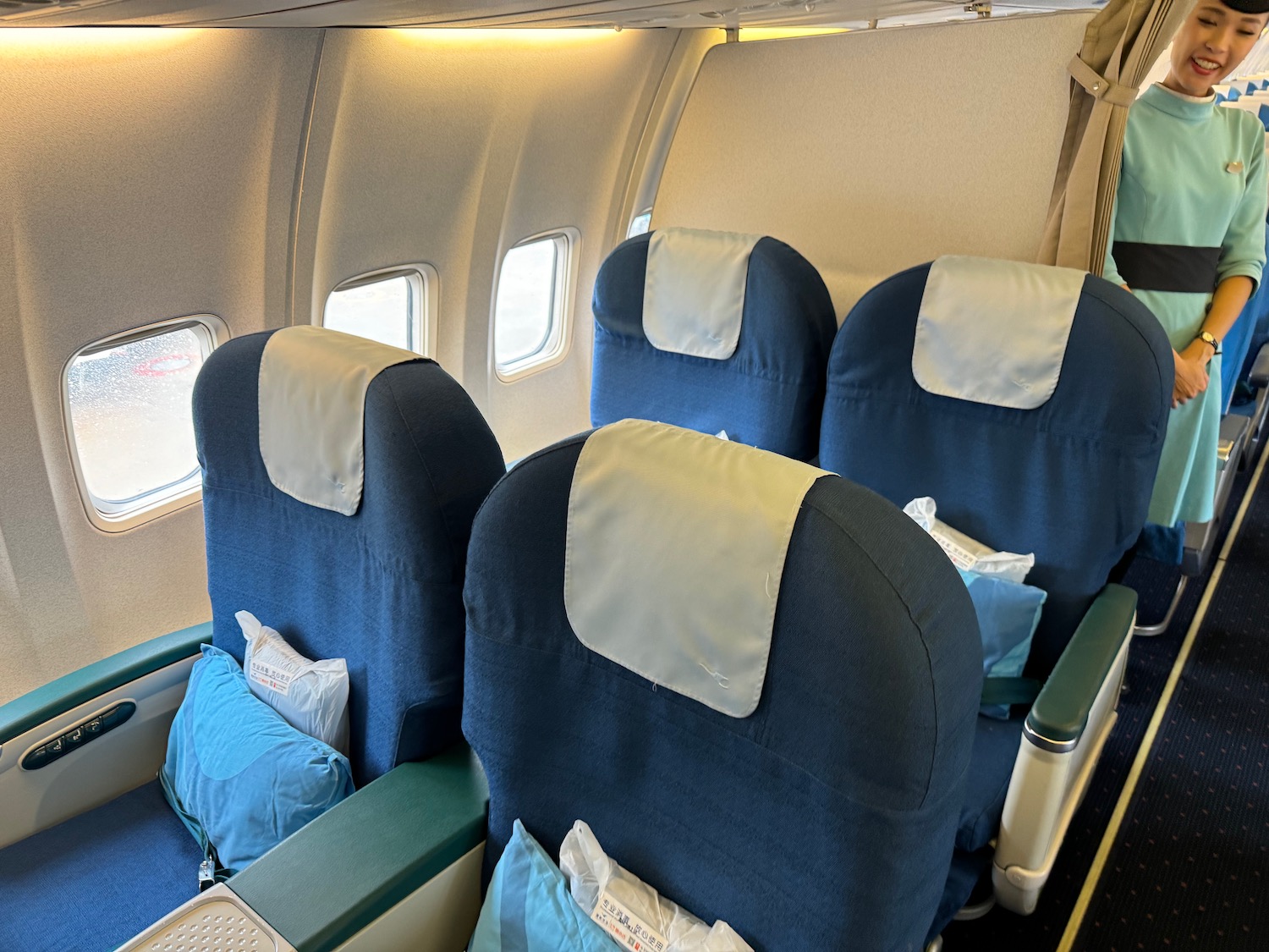 a row of blue and white seats in an airplane