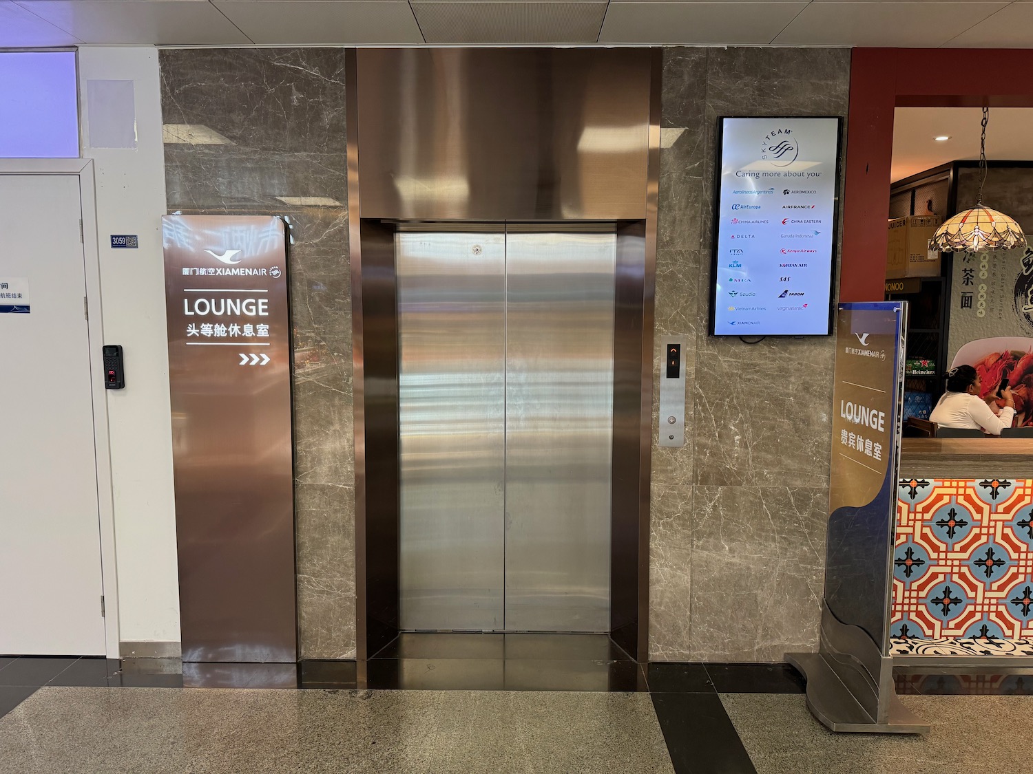 an elevator with a sign on the wall