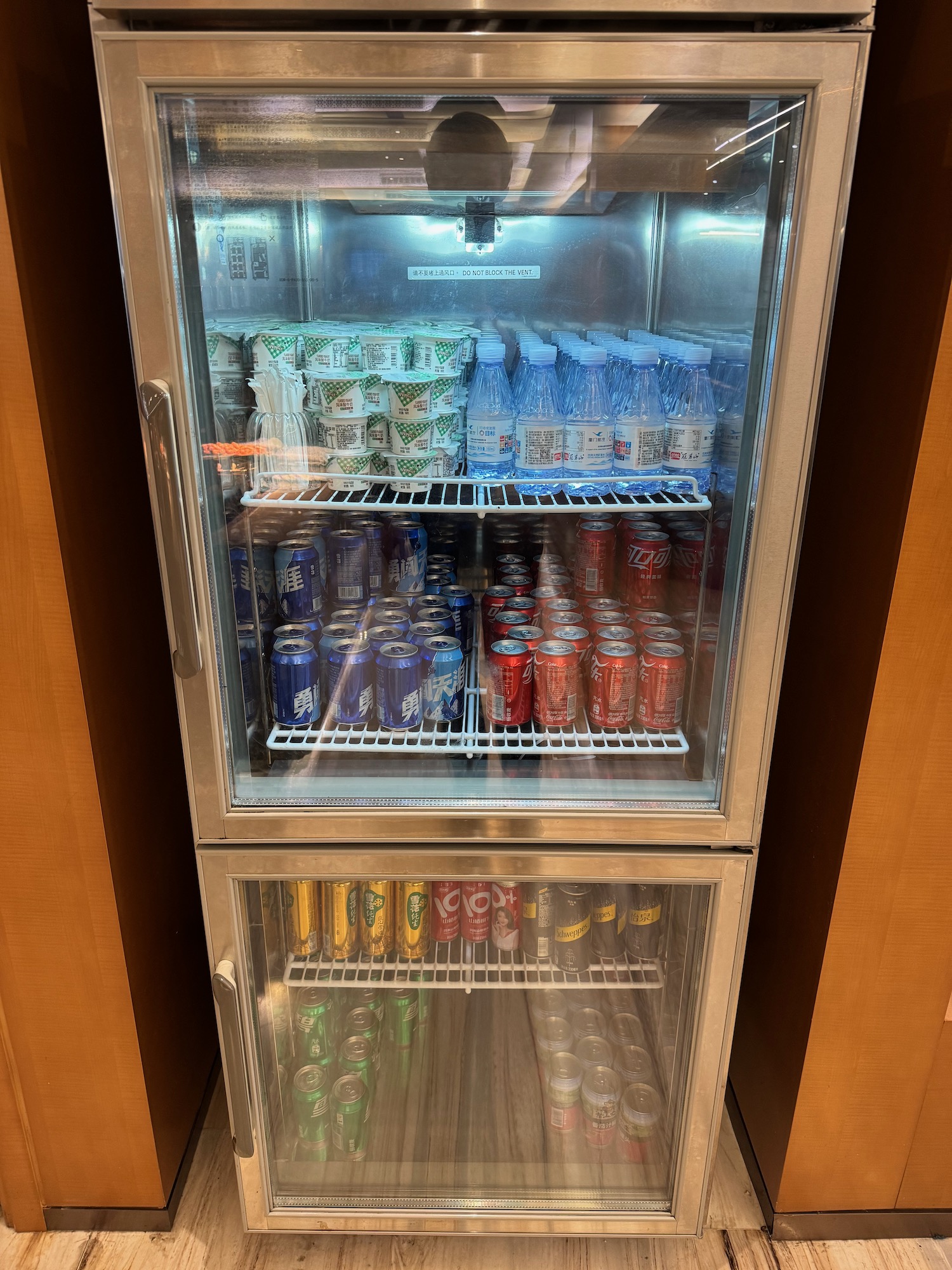 a refrigerator with drinks and cans