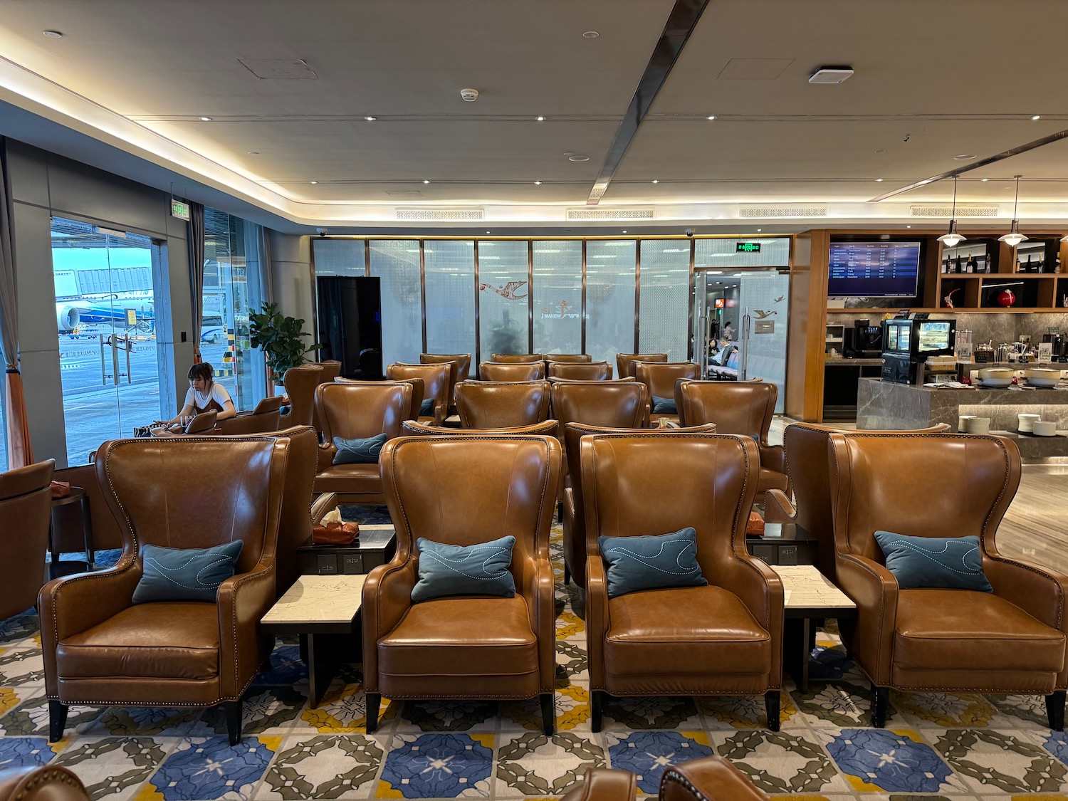 a room with brown leather chairs and tables