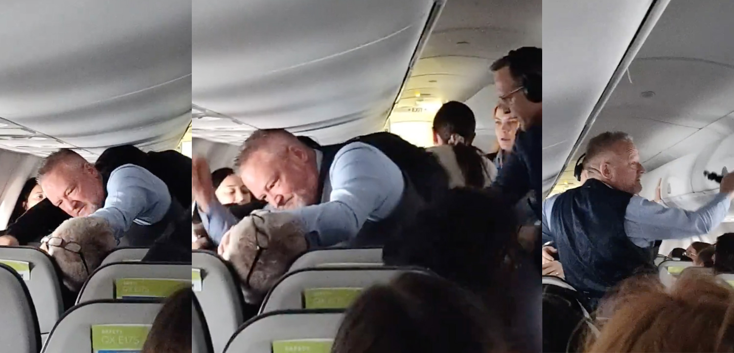 a man hugging a stuffed animal on an airplane