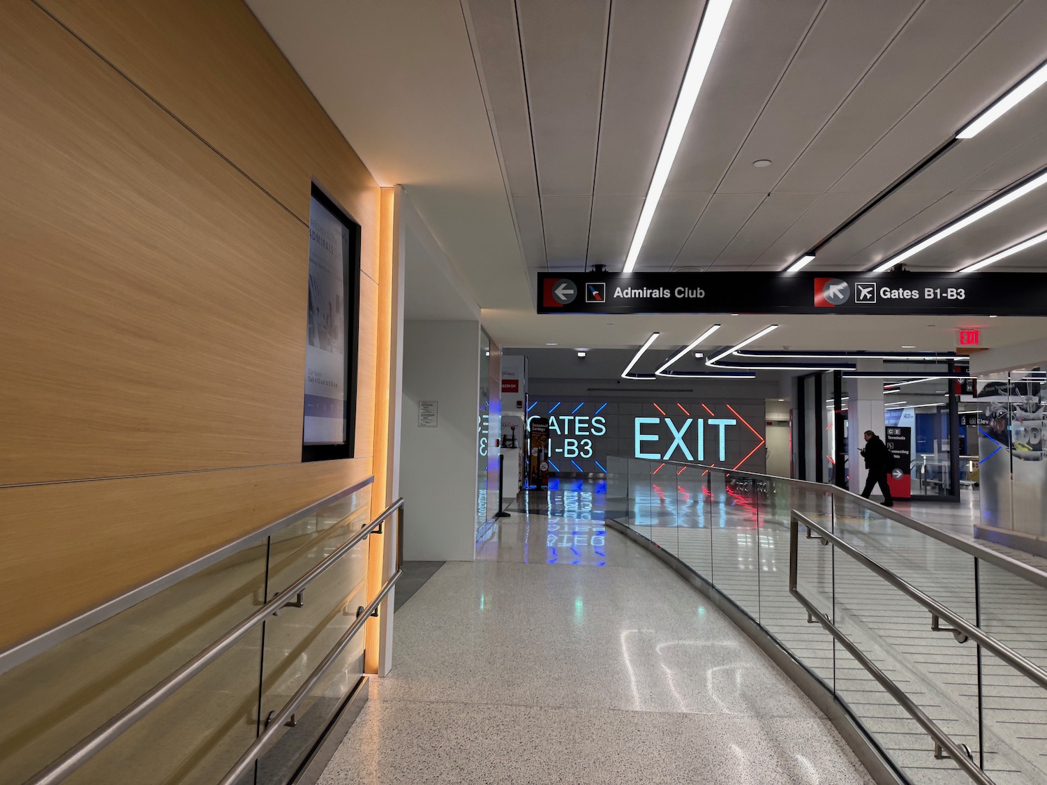 a walkway with a sign and a sign on the wall