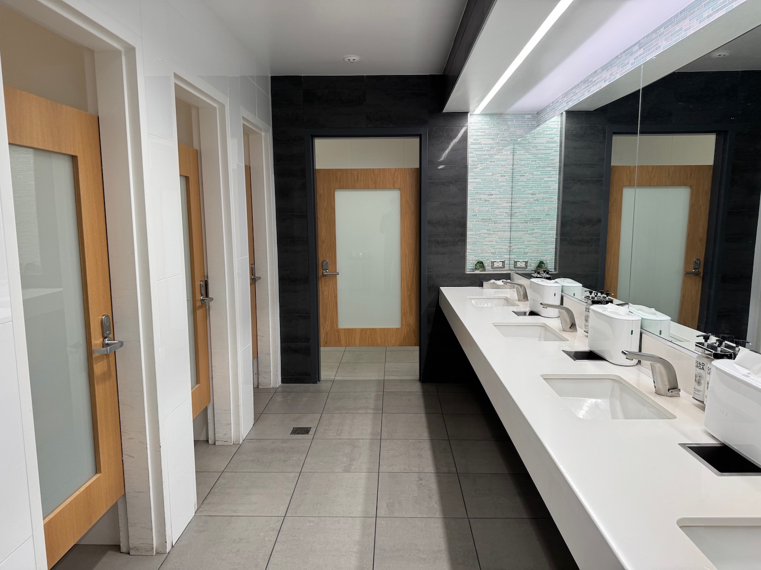 a bathroom with sinks and mirrors