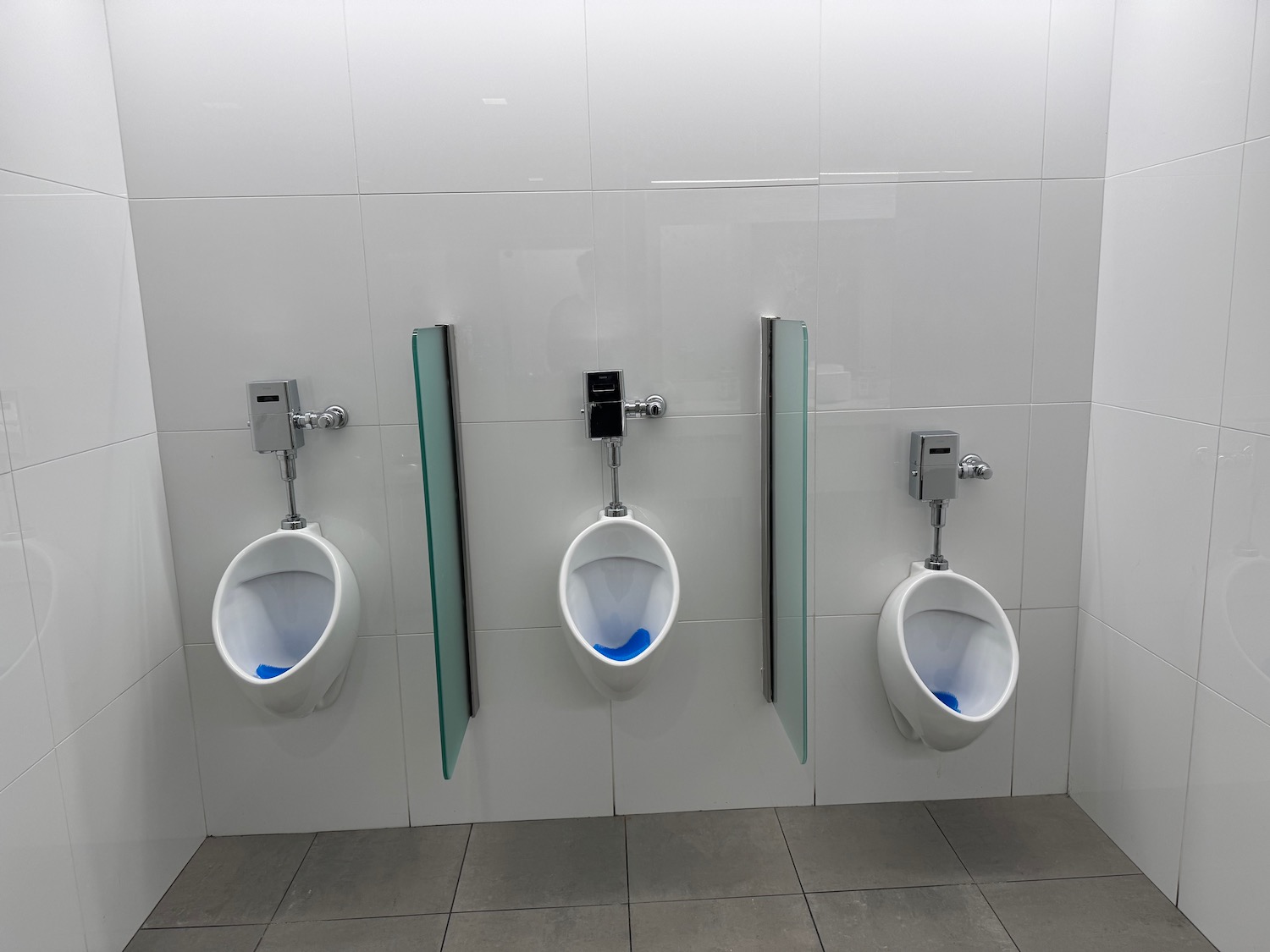 a row of urinals in a bathroom