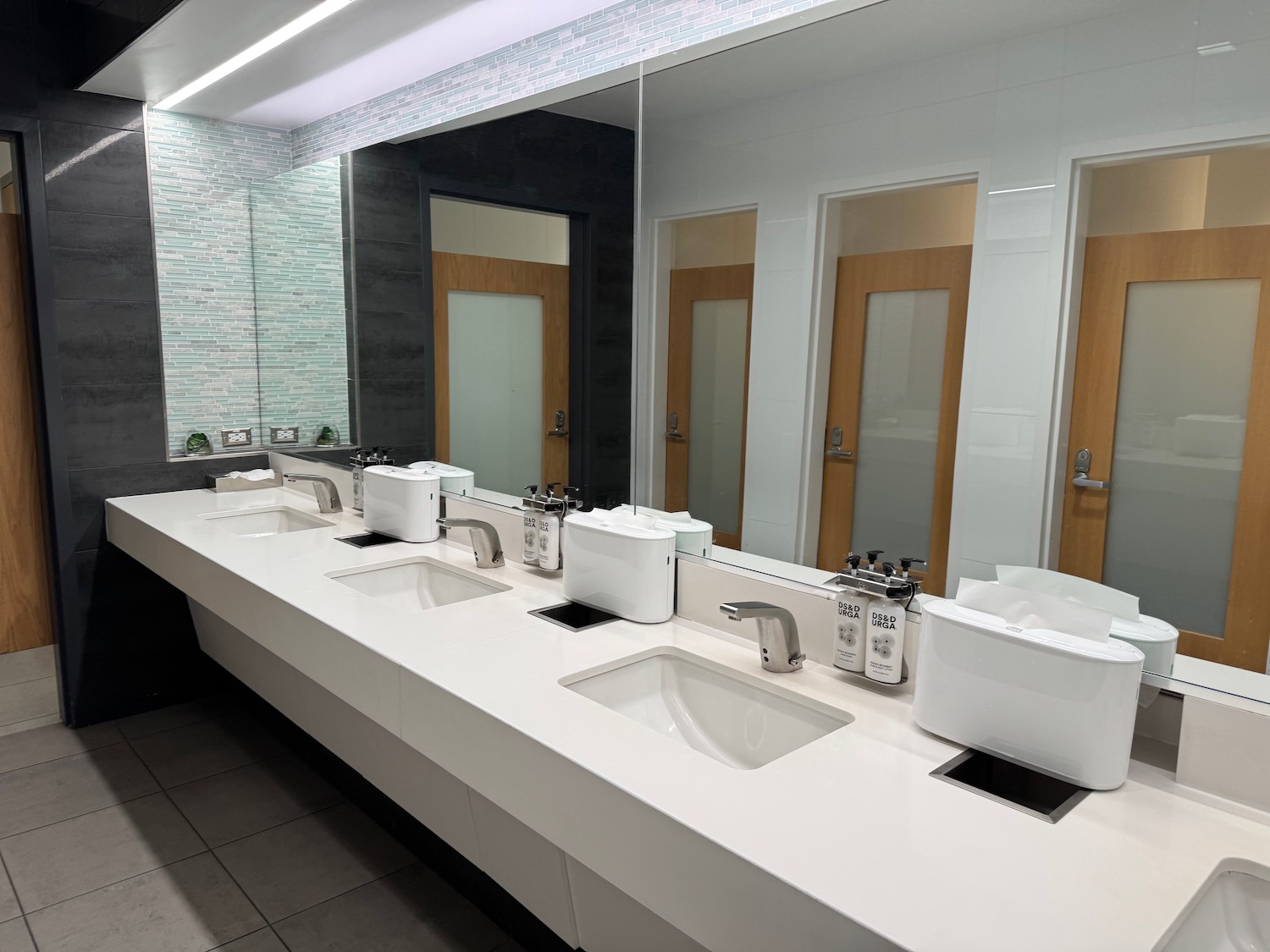 a bathroom with sinks and mirrors