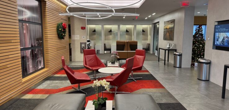 a lobby with red chairs and a table