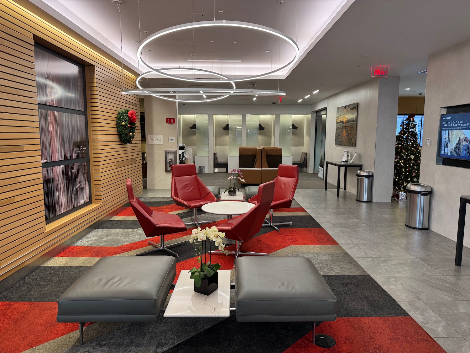 a lobby with red chairs and a table