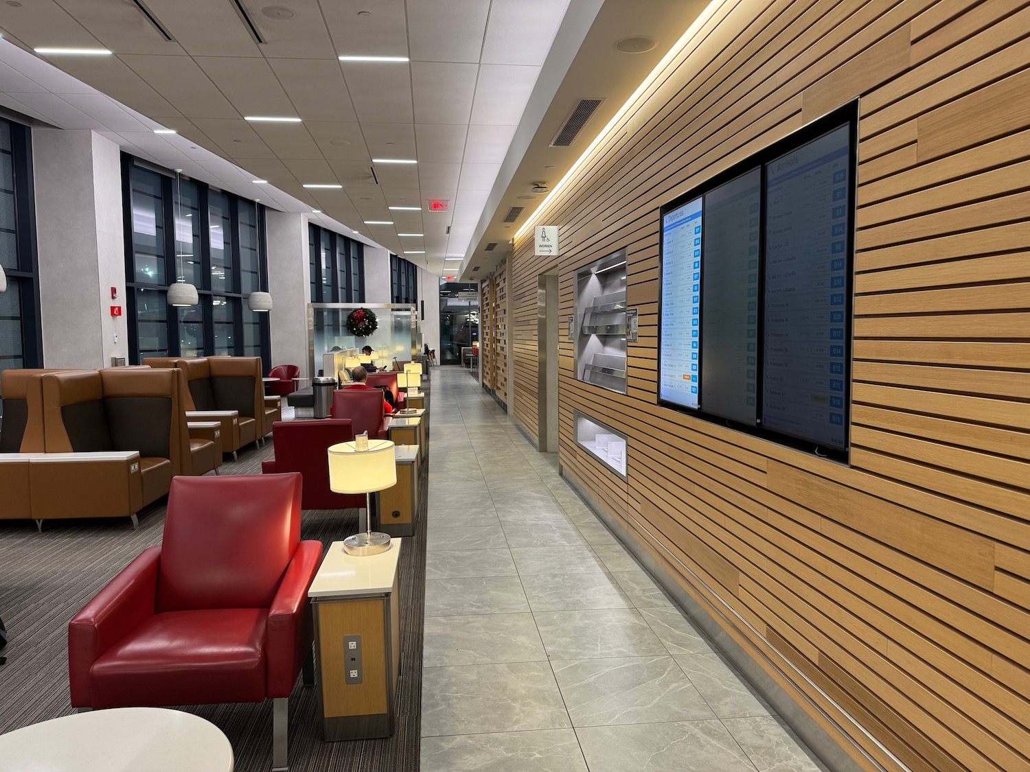 a long room with chairs and a large screen on the wall