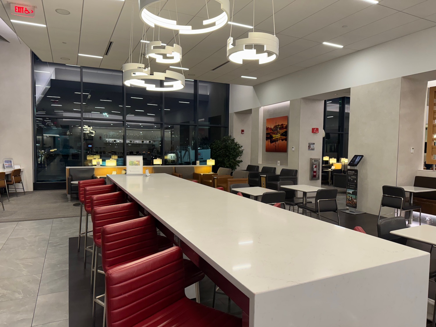 a long table with chairs and a chandelier in a room