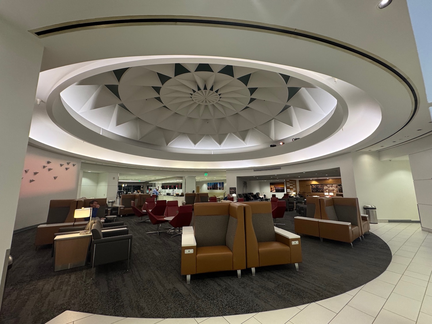 a room with a circular ceiling and chairs