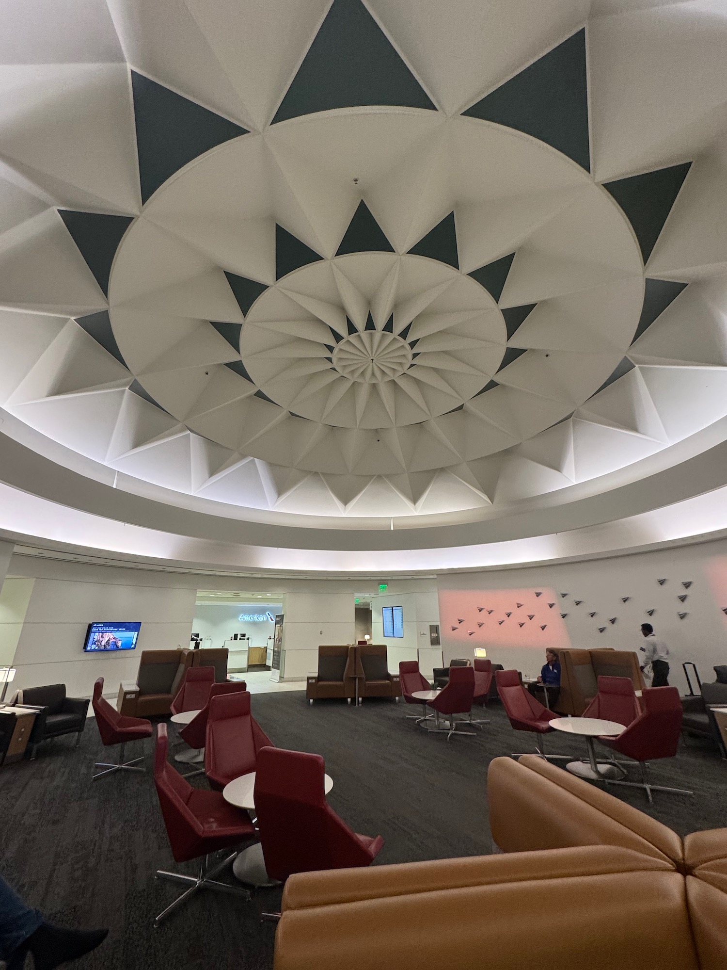 a room with chairs and a circular ceiling