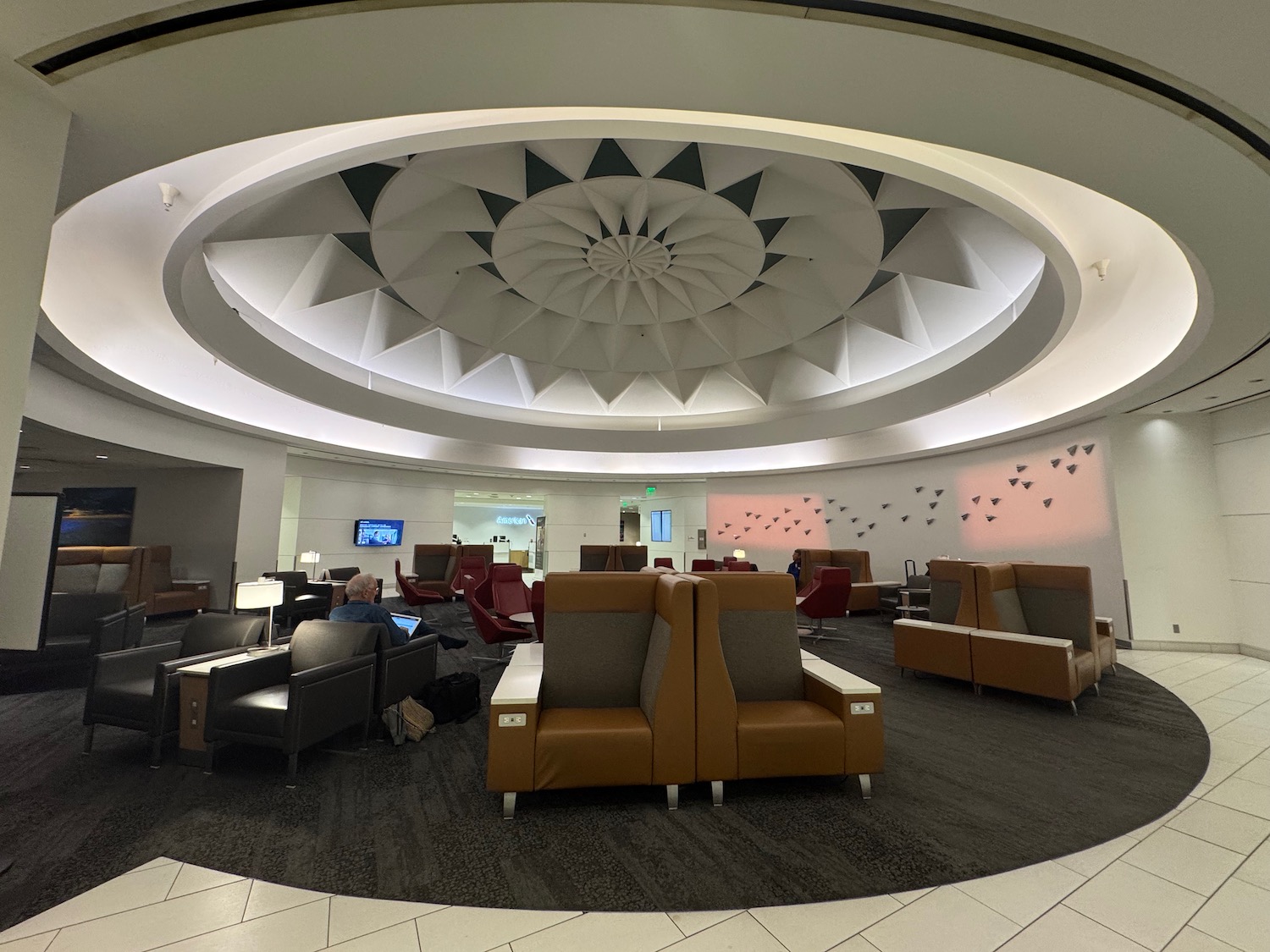 a room with couches and a circular ceiling