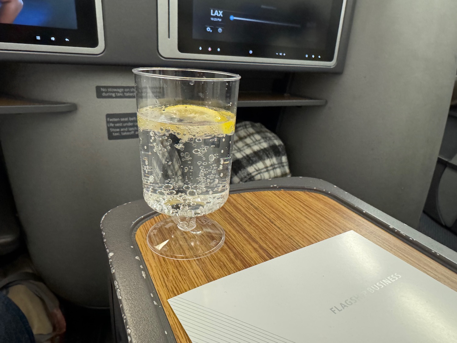 a glass of water with a lemon on a table