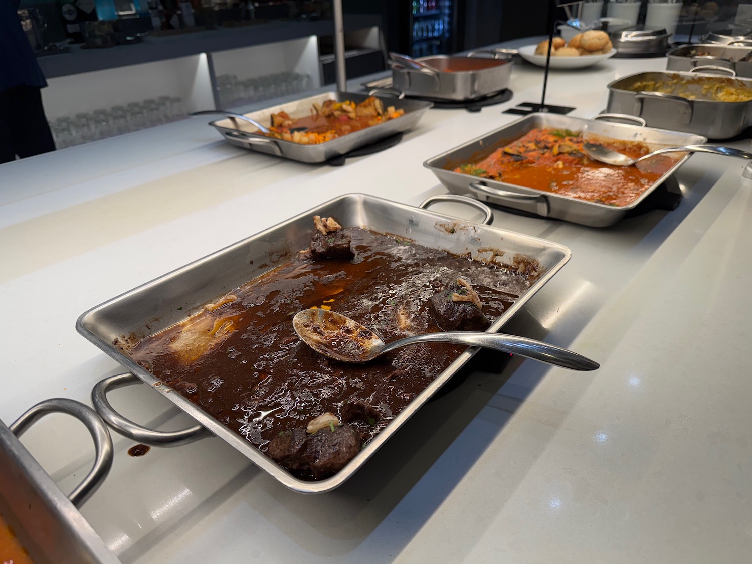 a group of metal pans with food on a table