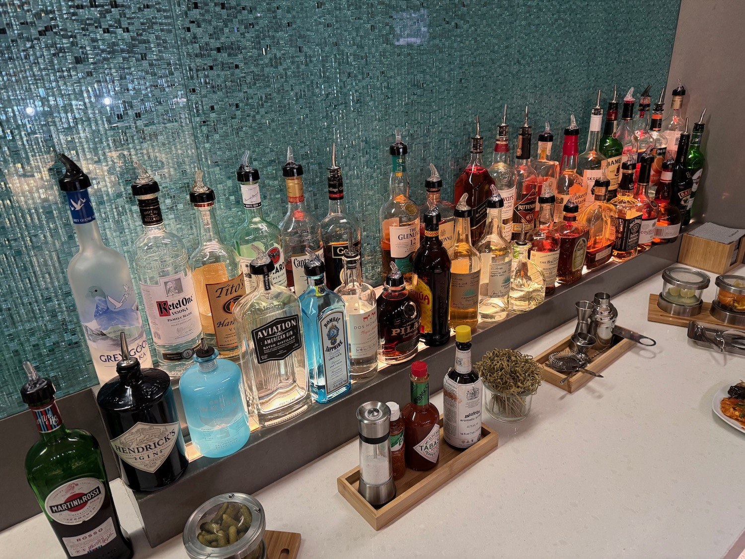 a group of bottles of alcohol on a bar