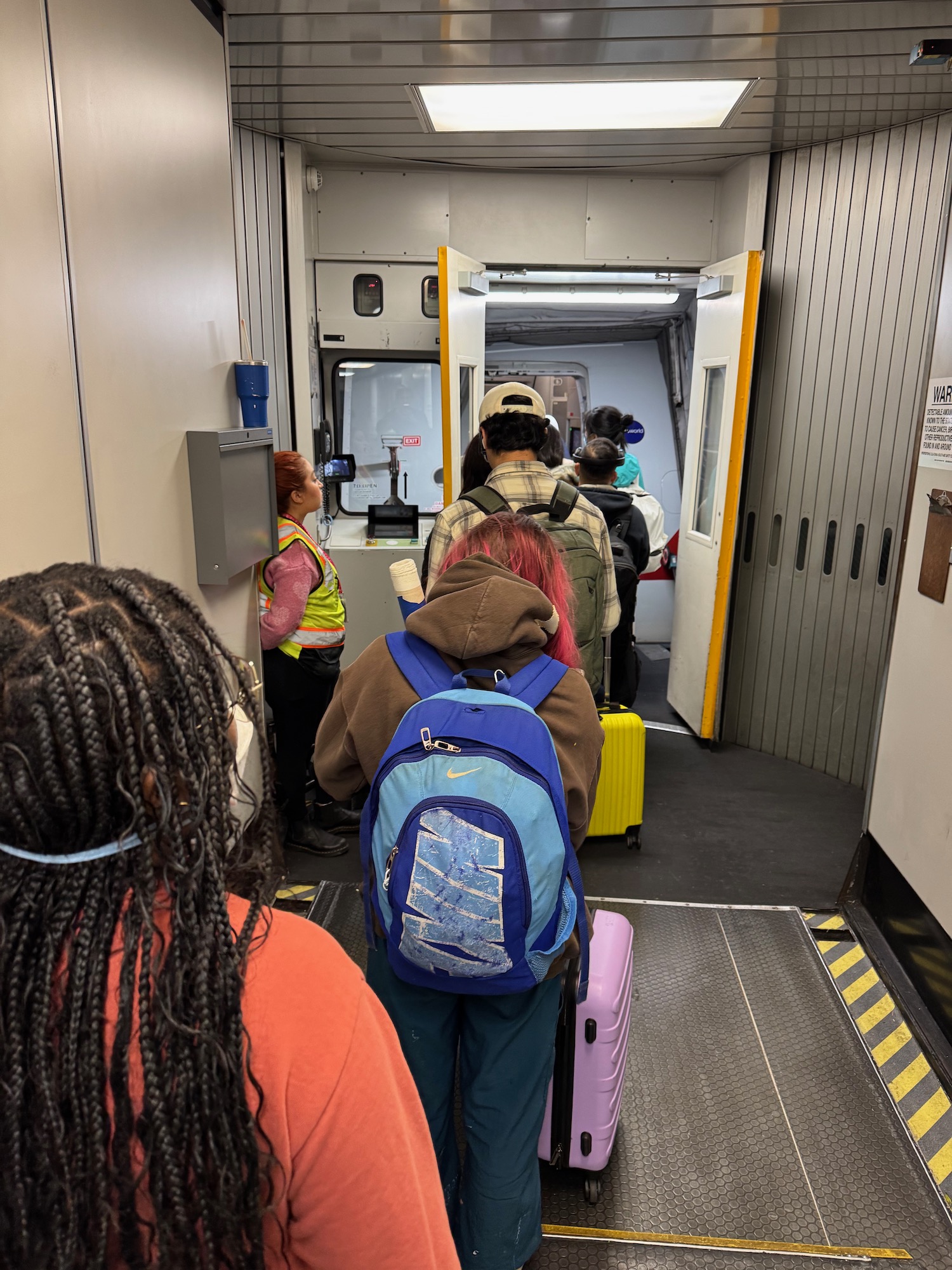 a group of people walking in a hallway