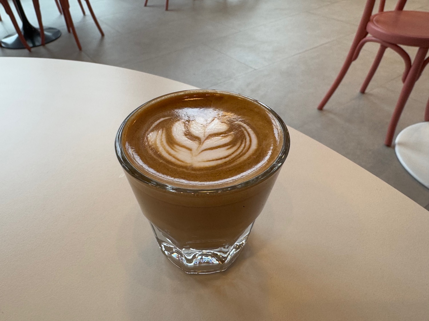 a glass of coffee on a table