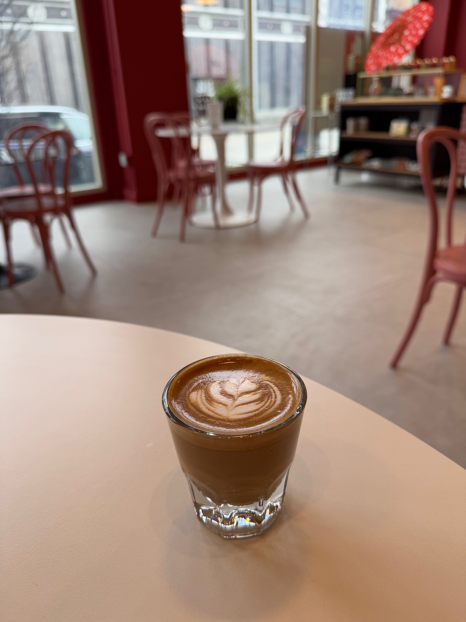 a glass of coffee on a table