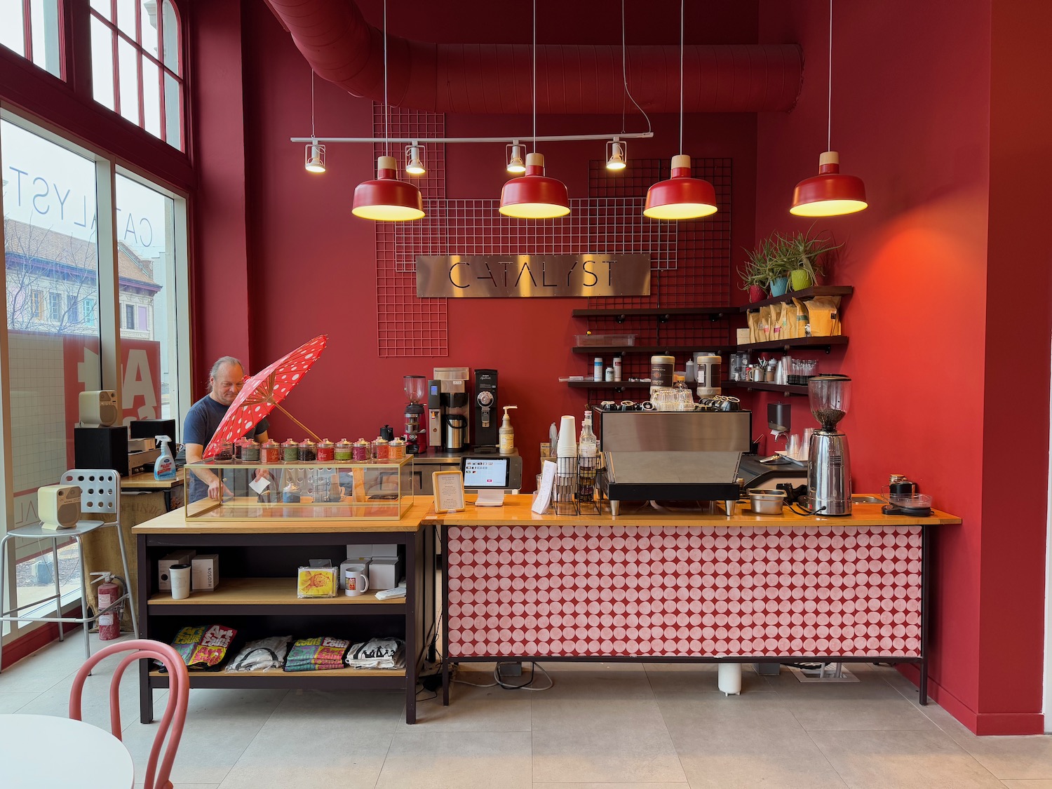 a man behind a counter in a red and white room