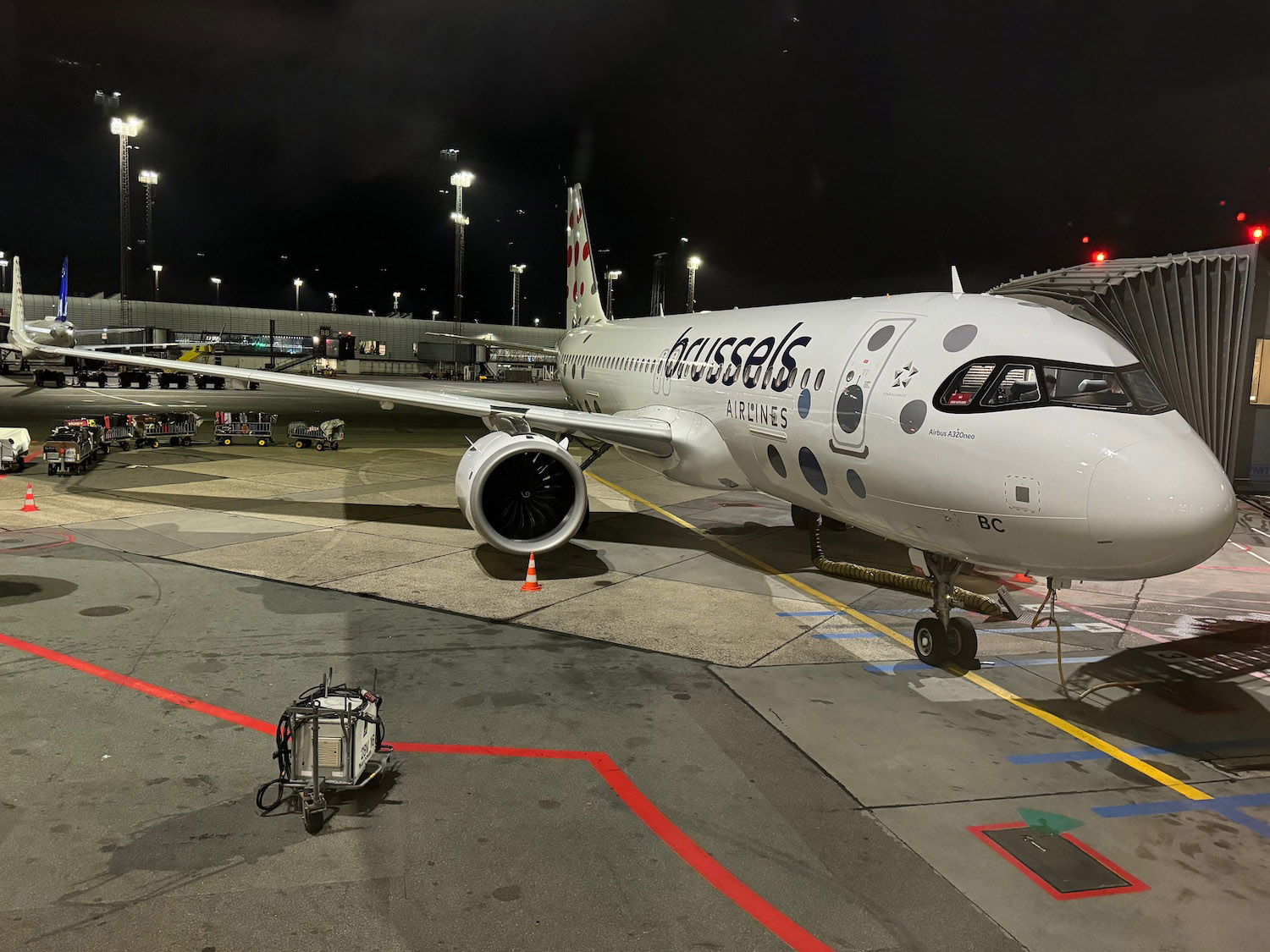 a white airplane on a runway at night