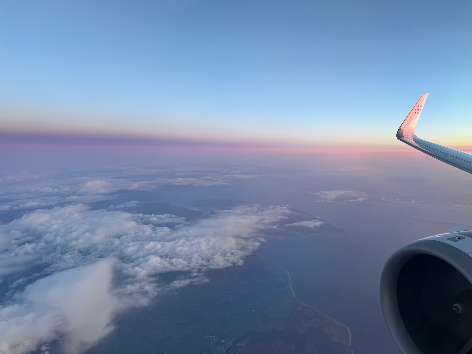 an airplane wing and a body of water