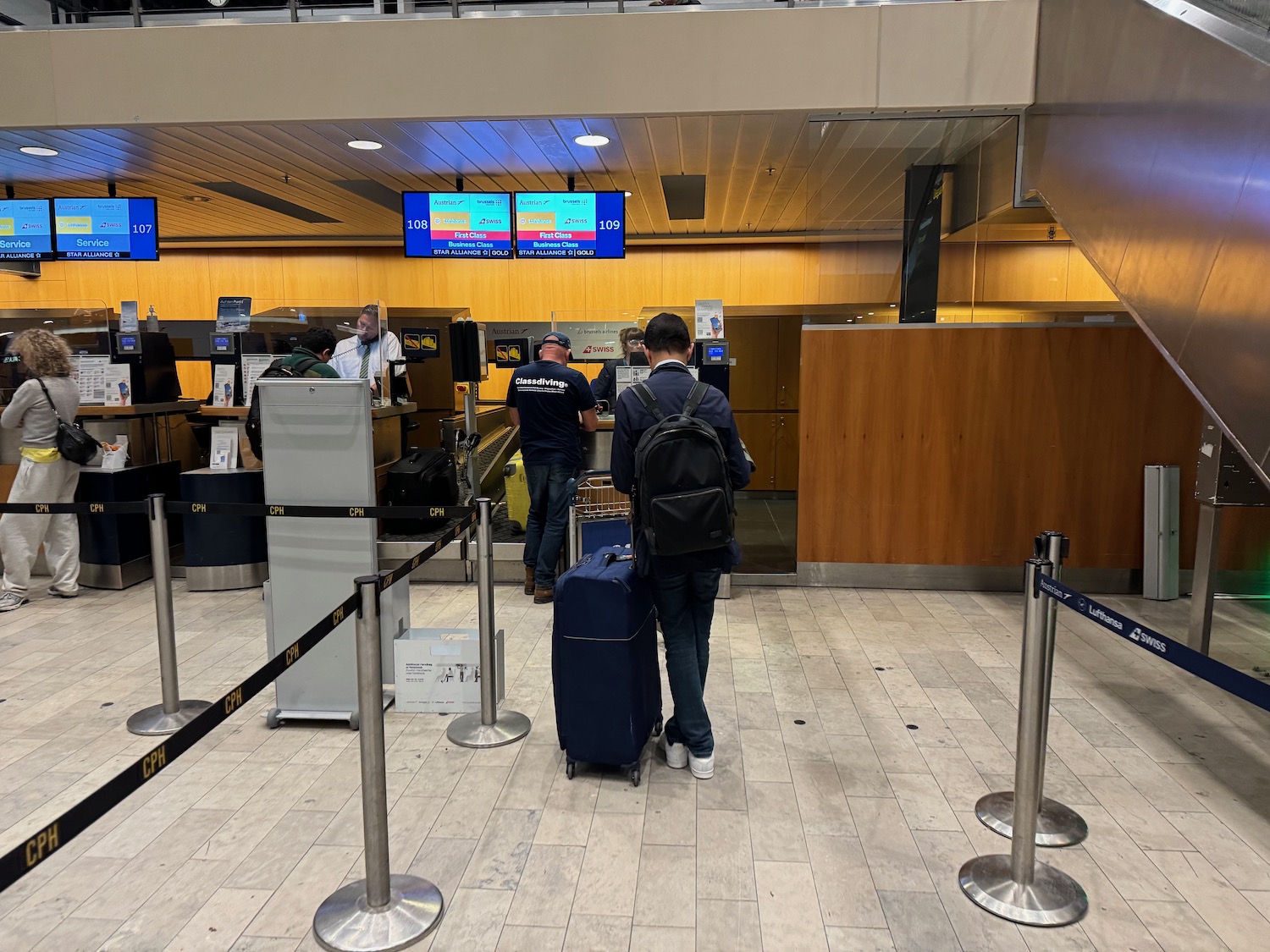 people standing in a line at an airport