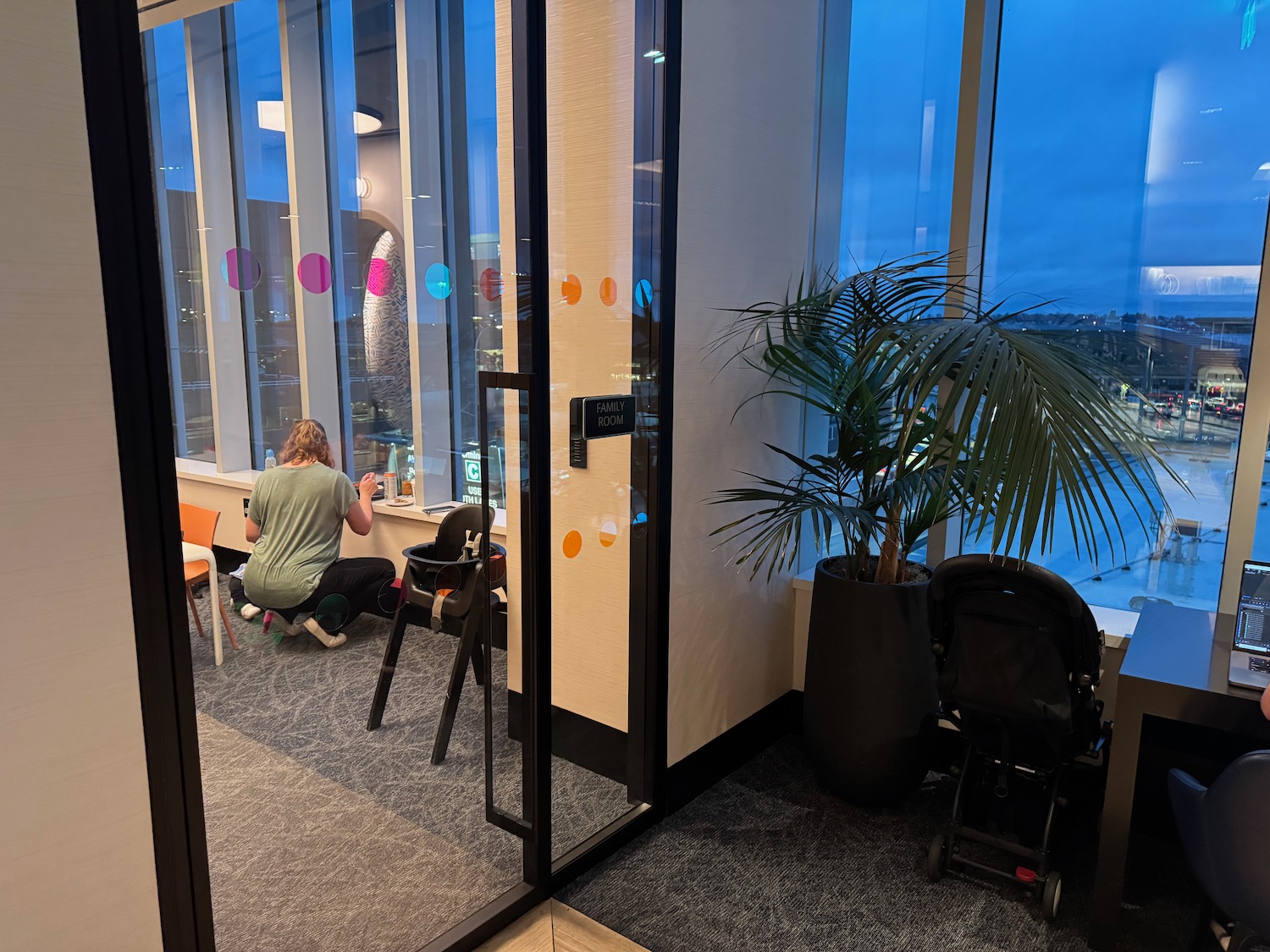 a person sitting at a table in front of a glass door