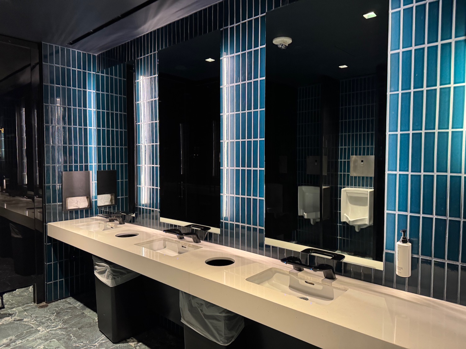 a bathroom with sinks and mirrors