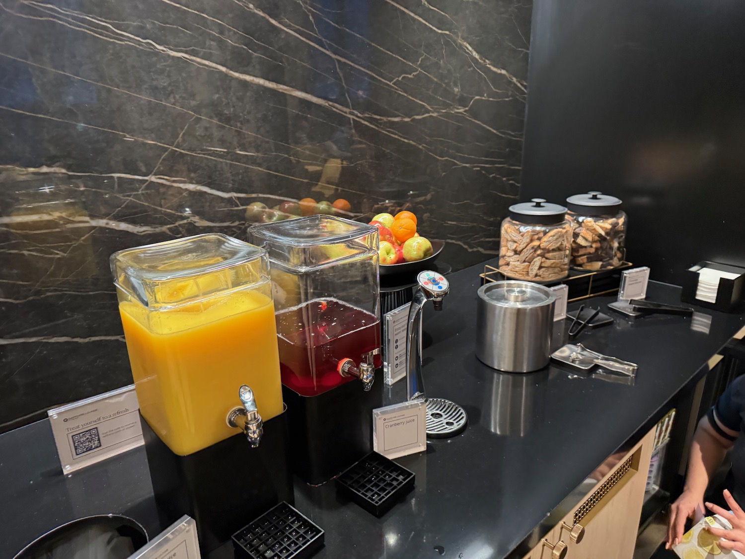 a group of juice dispensers on a counter