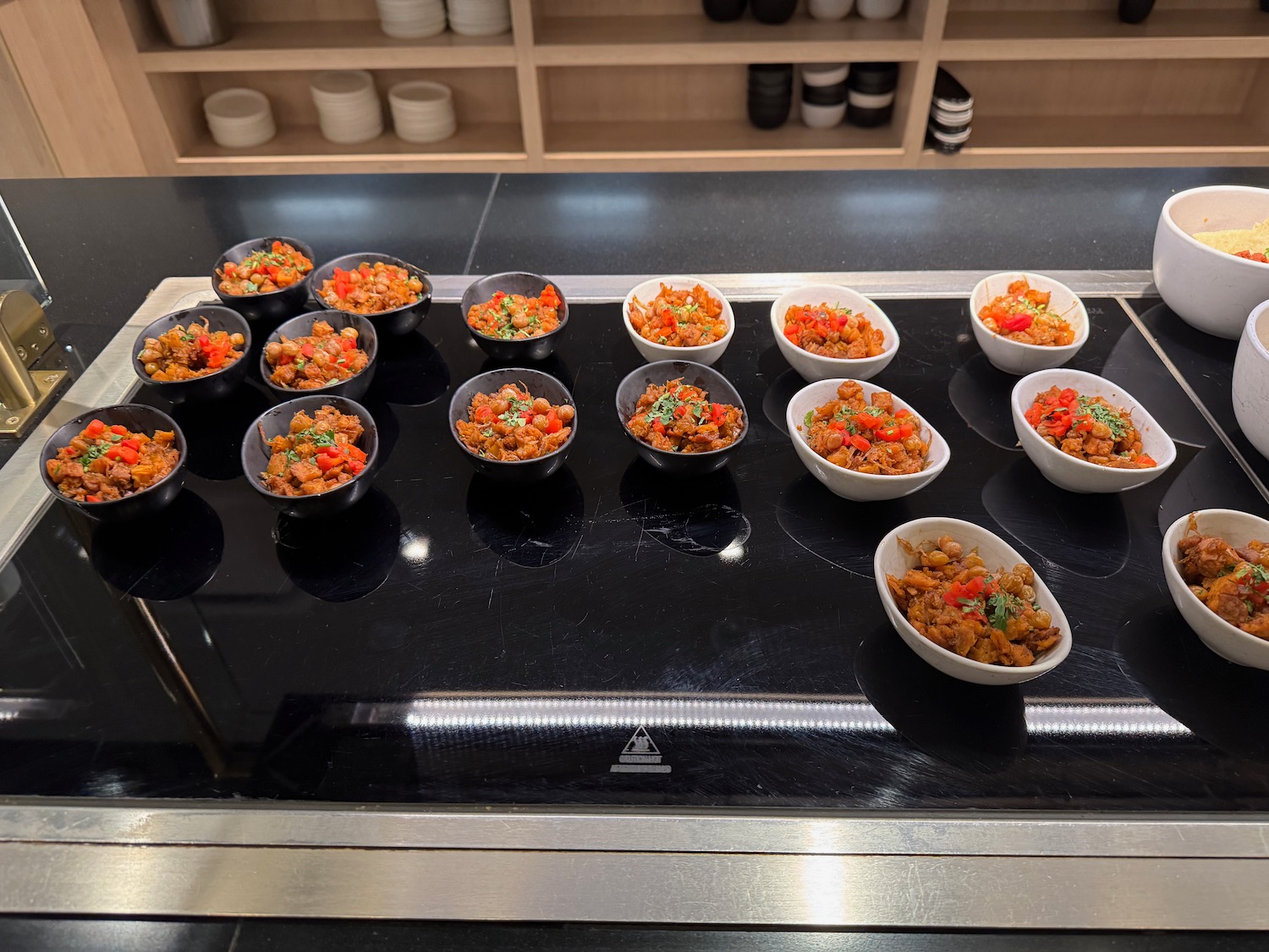 a group of bowls of food on a stove top