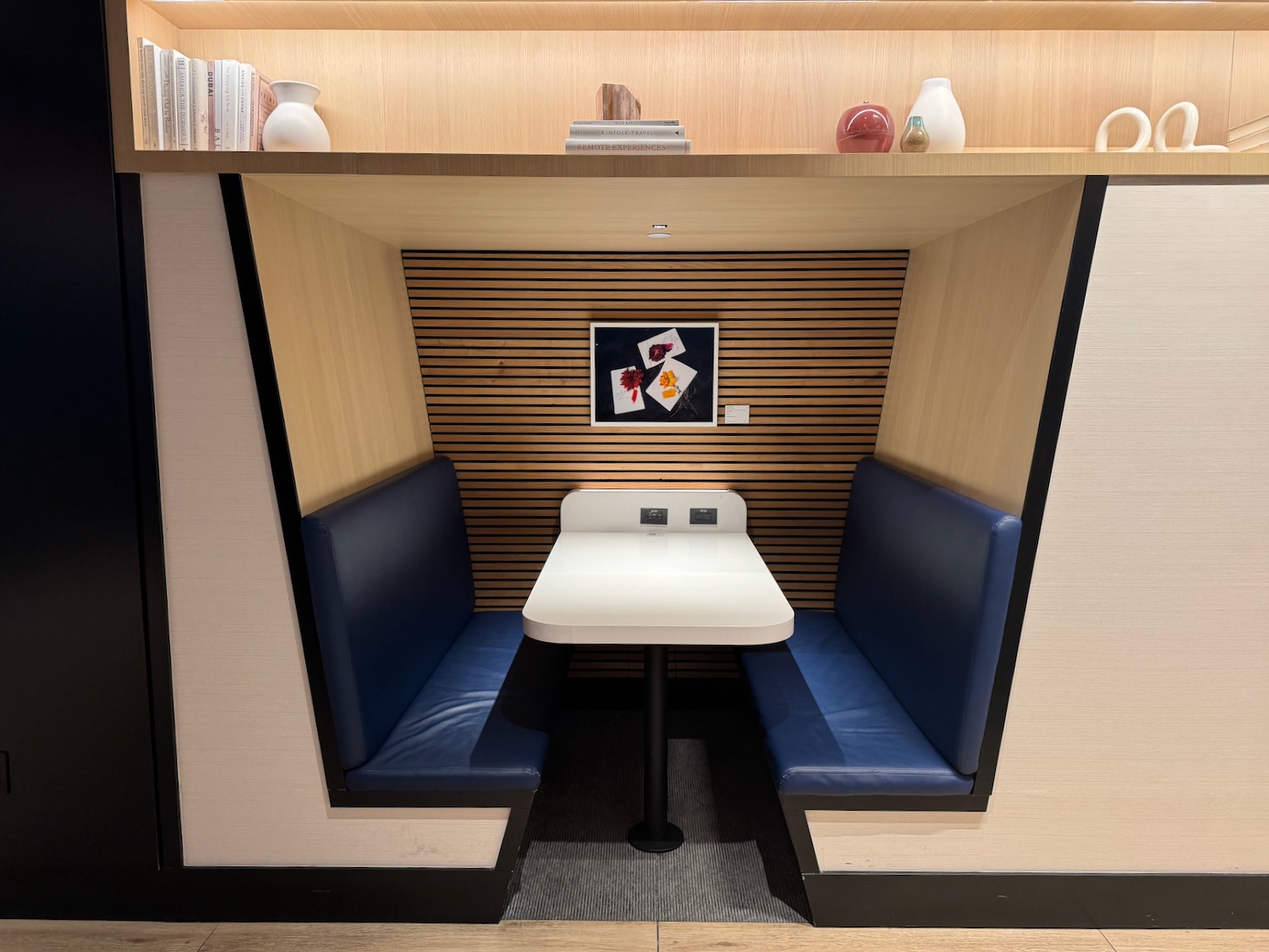 a booth with blue seats and a table