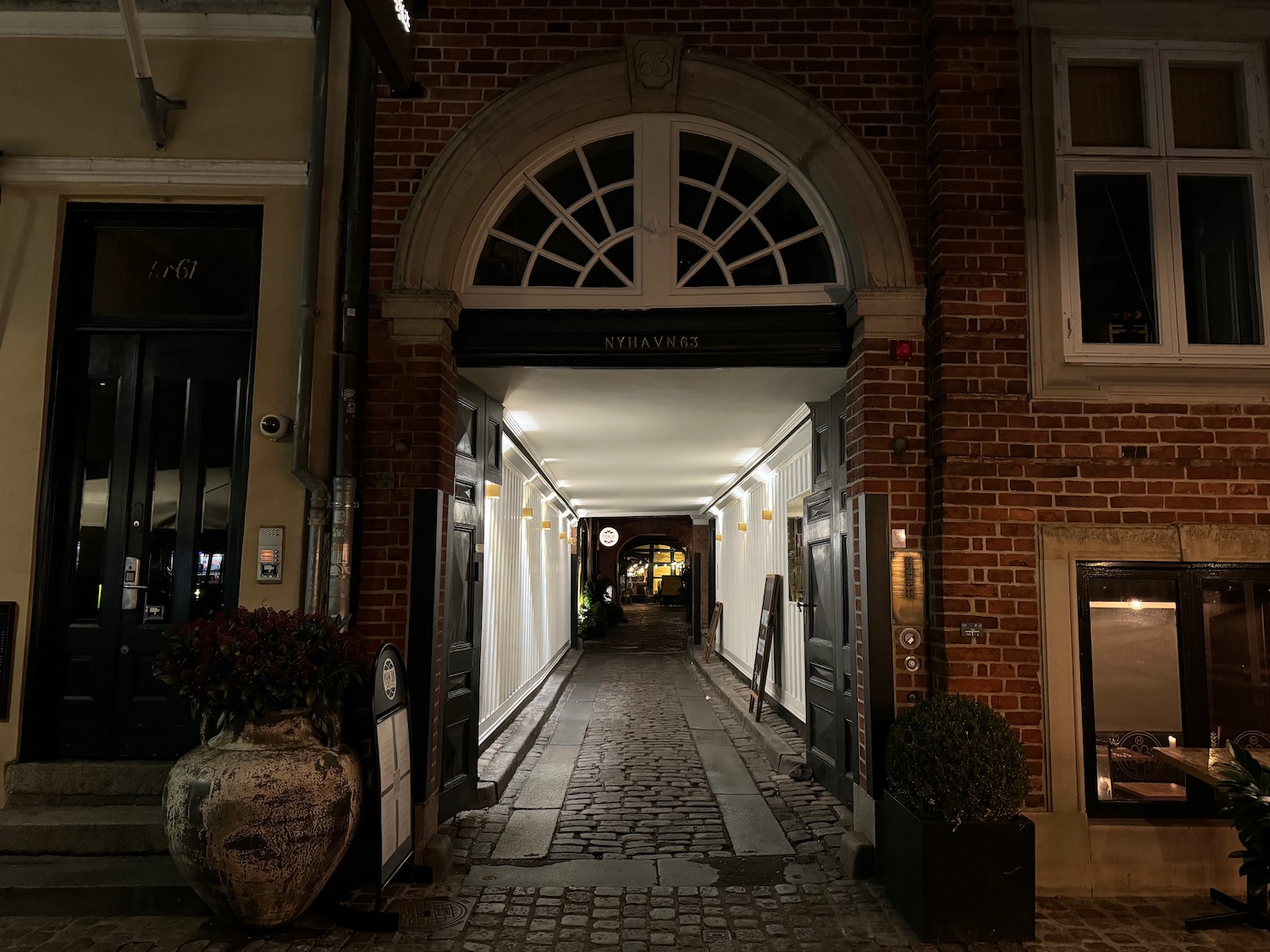 a brick building with a walkway and a door