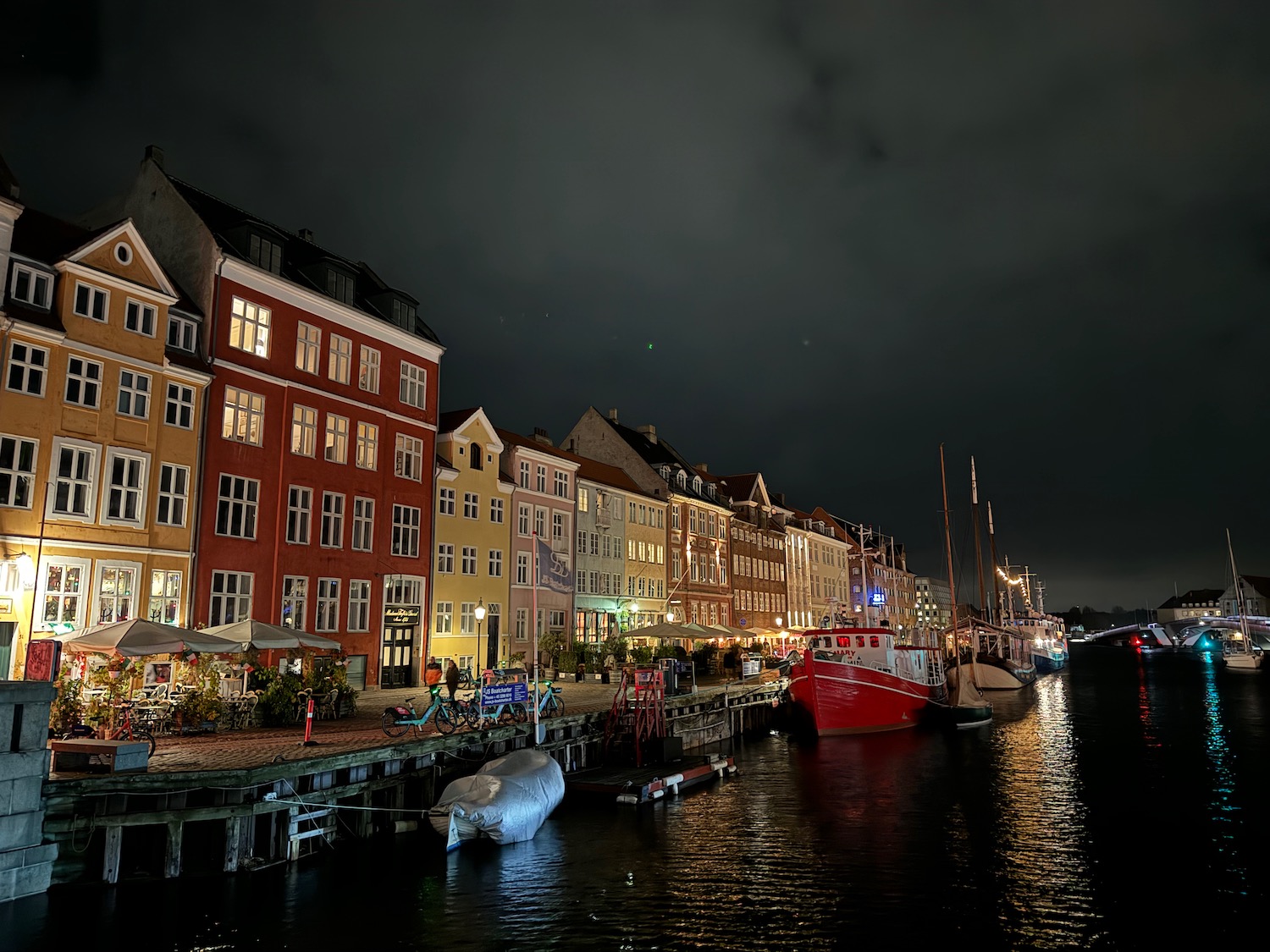 a city at night with boats on water