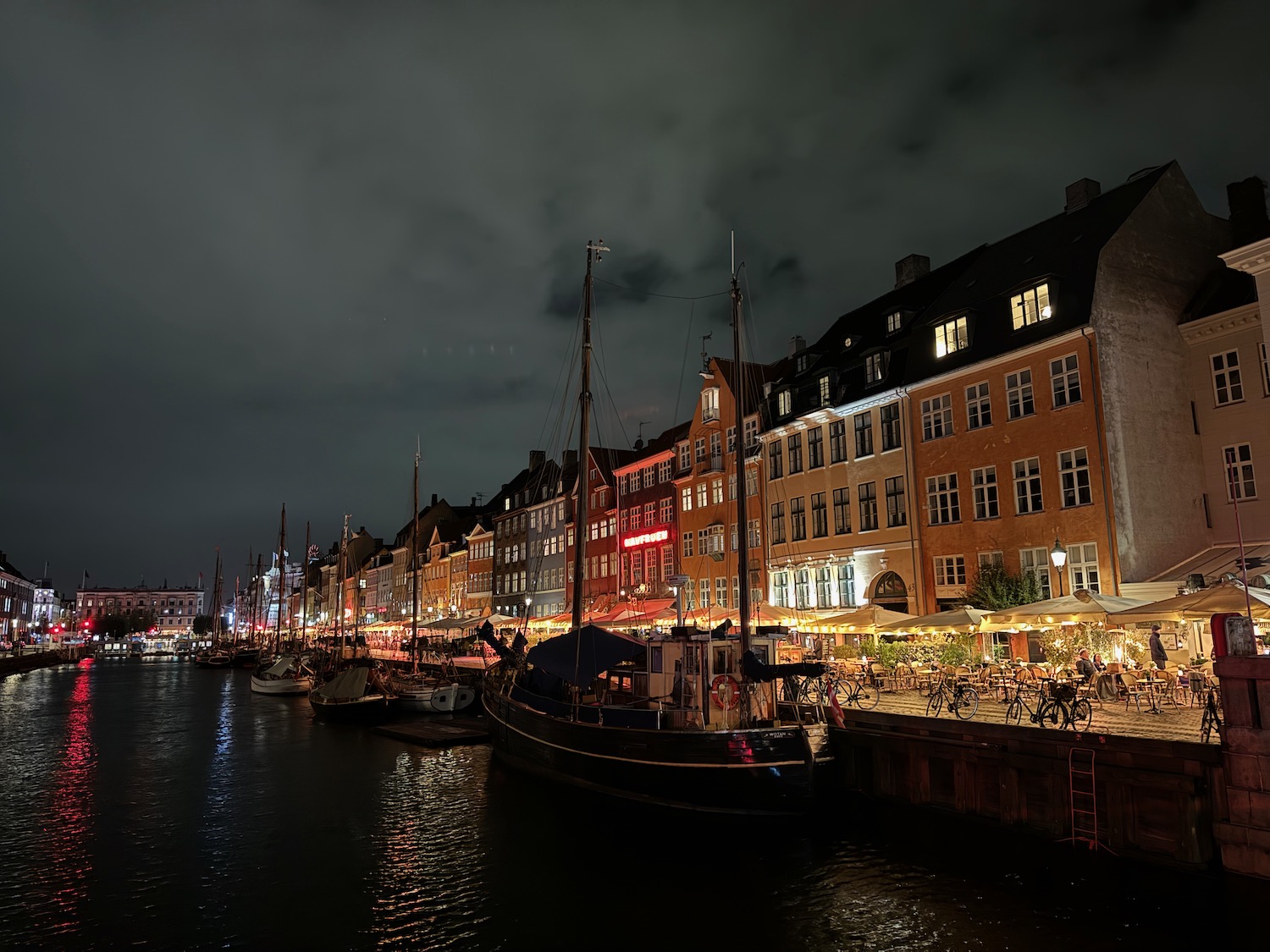 a row of buildings along a body of water at night