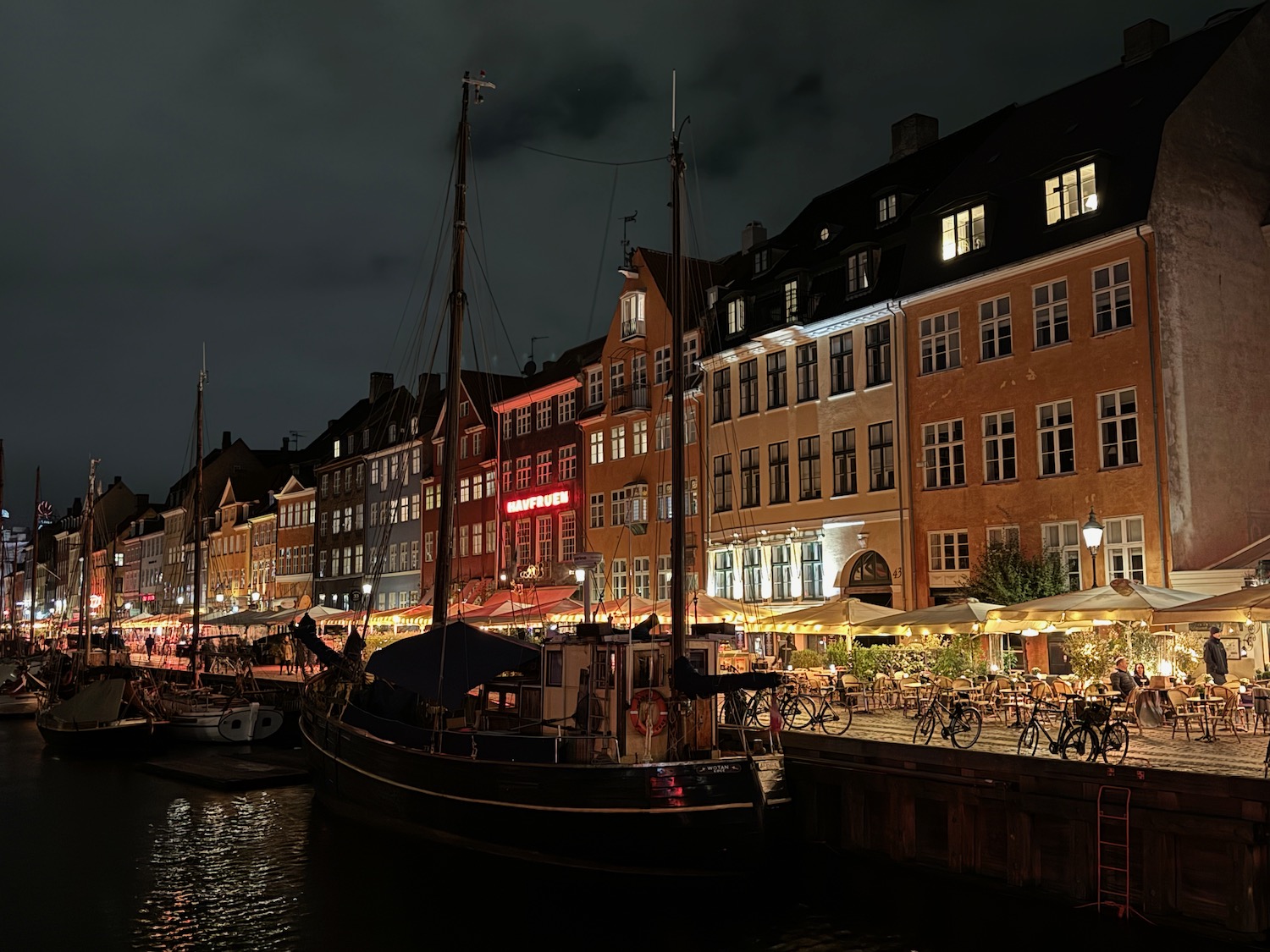 boats on a dock by buildings at night