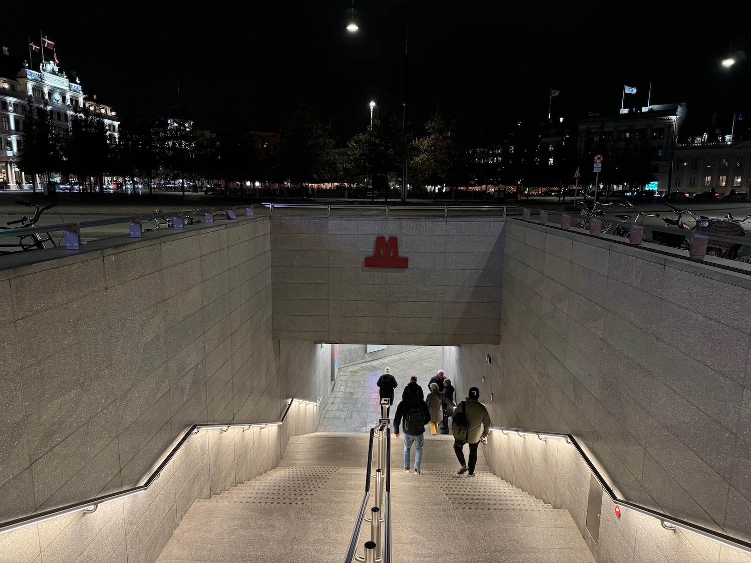 a group of people walking up a concrete staircase