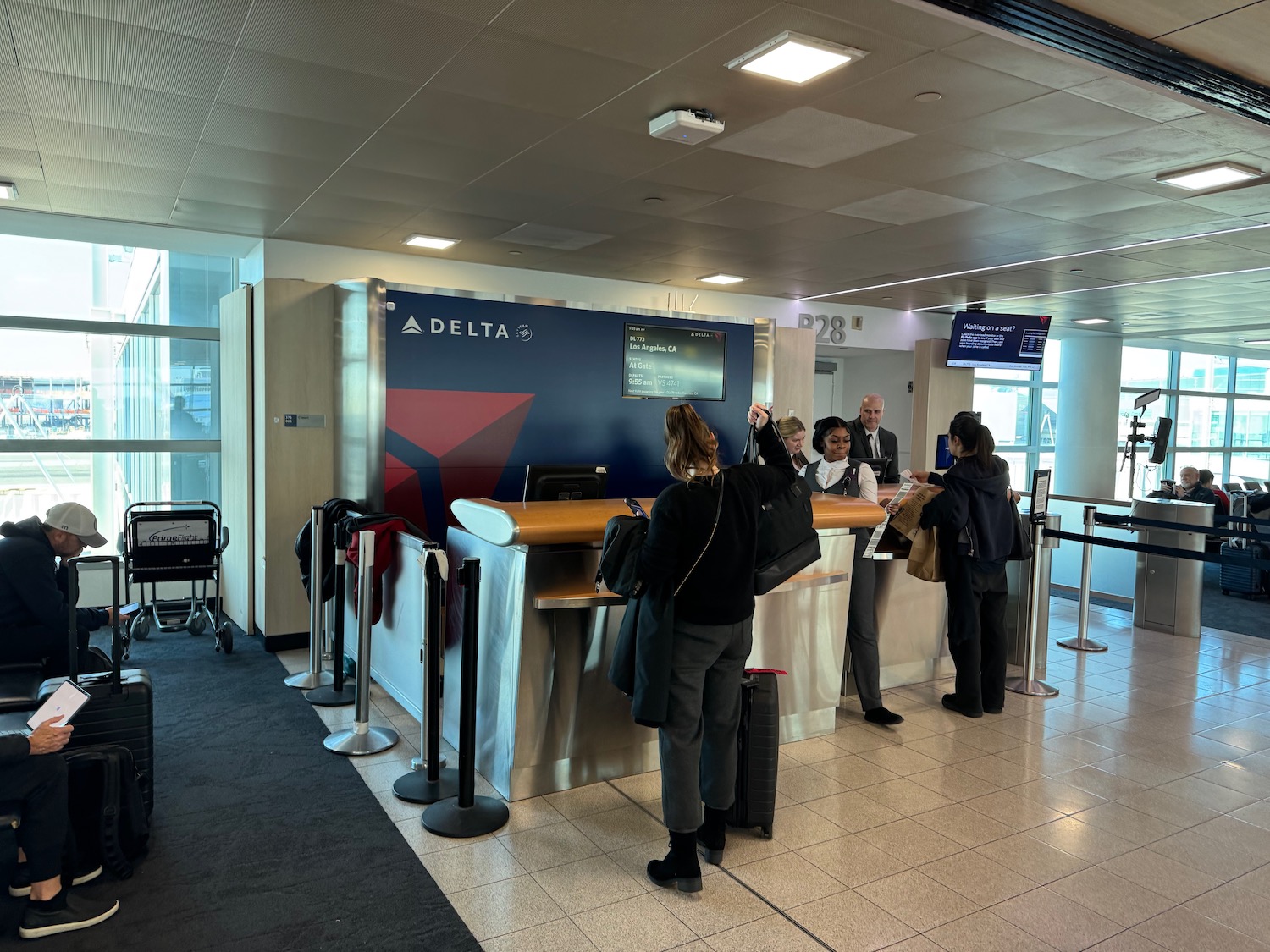 people standing at a counter in a airport